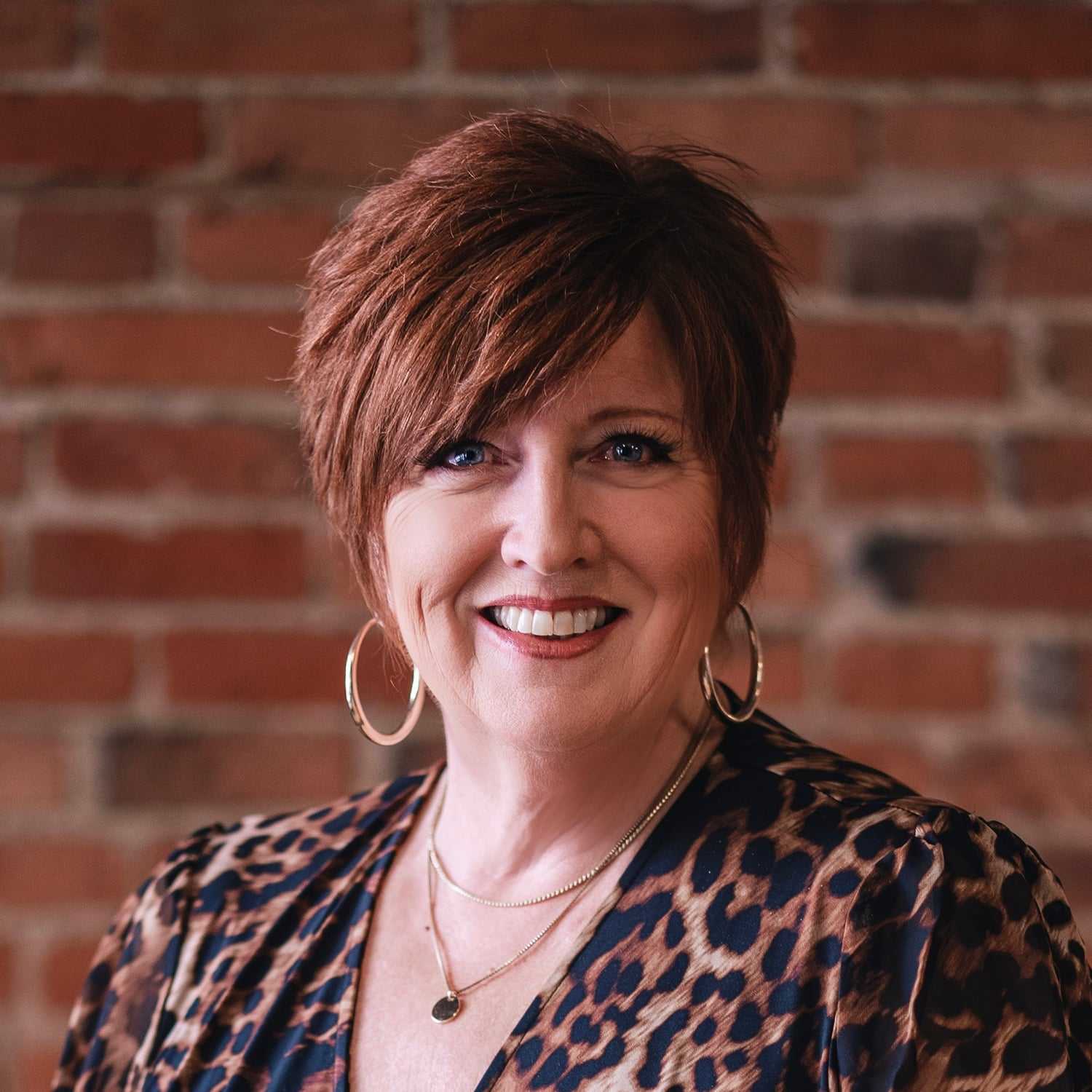Portrait of Terrie McNeil, a professional stylist at That Hair Place, showcasing their expertise and style.