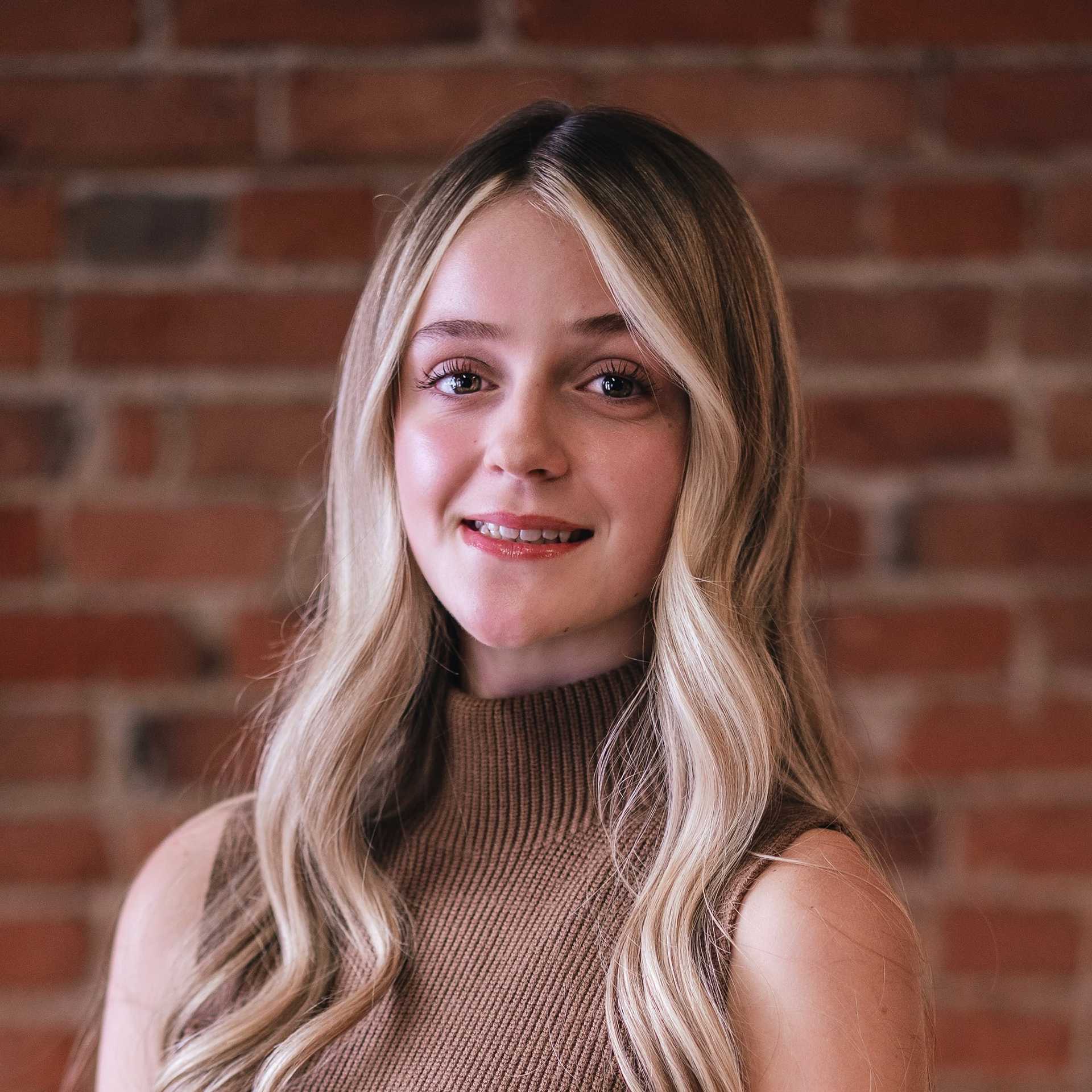 Portrait of Marlie Greer, a professional stylist at That Hair Place, showcasing their expertise and style.