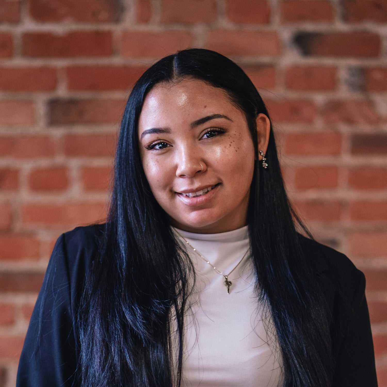 Portrait of Yacenia Sabari, a professional stylist at That Hair Place, showcasing their expertise and style.