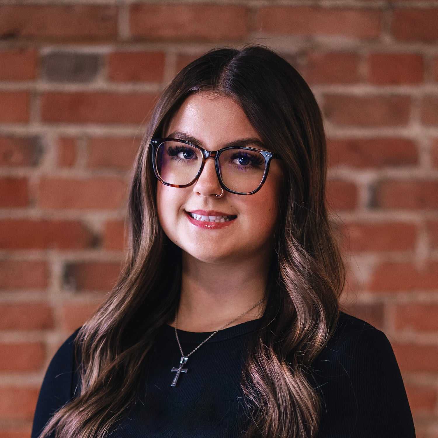 Portrait of Adriana Richer, a professional stylist at That Hair Place, showcasing their expertise and style.